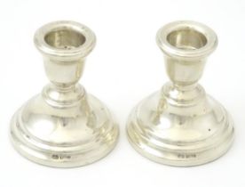 A pair of silver squat candlesticks, hallmarked Birmingham 1963 maker Sanders and MacKenzie,