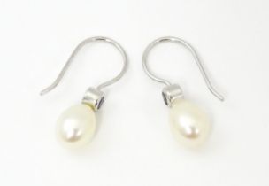 A 14ct white gold drop earrings set with pearls and pale blue stones. Approx. 3/4" long Please