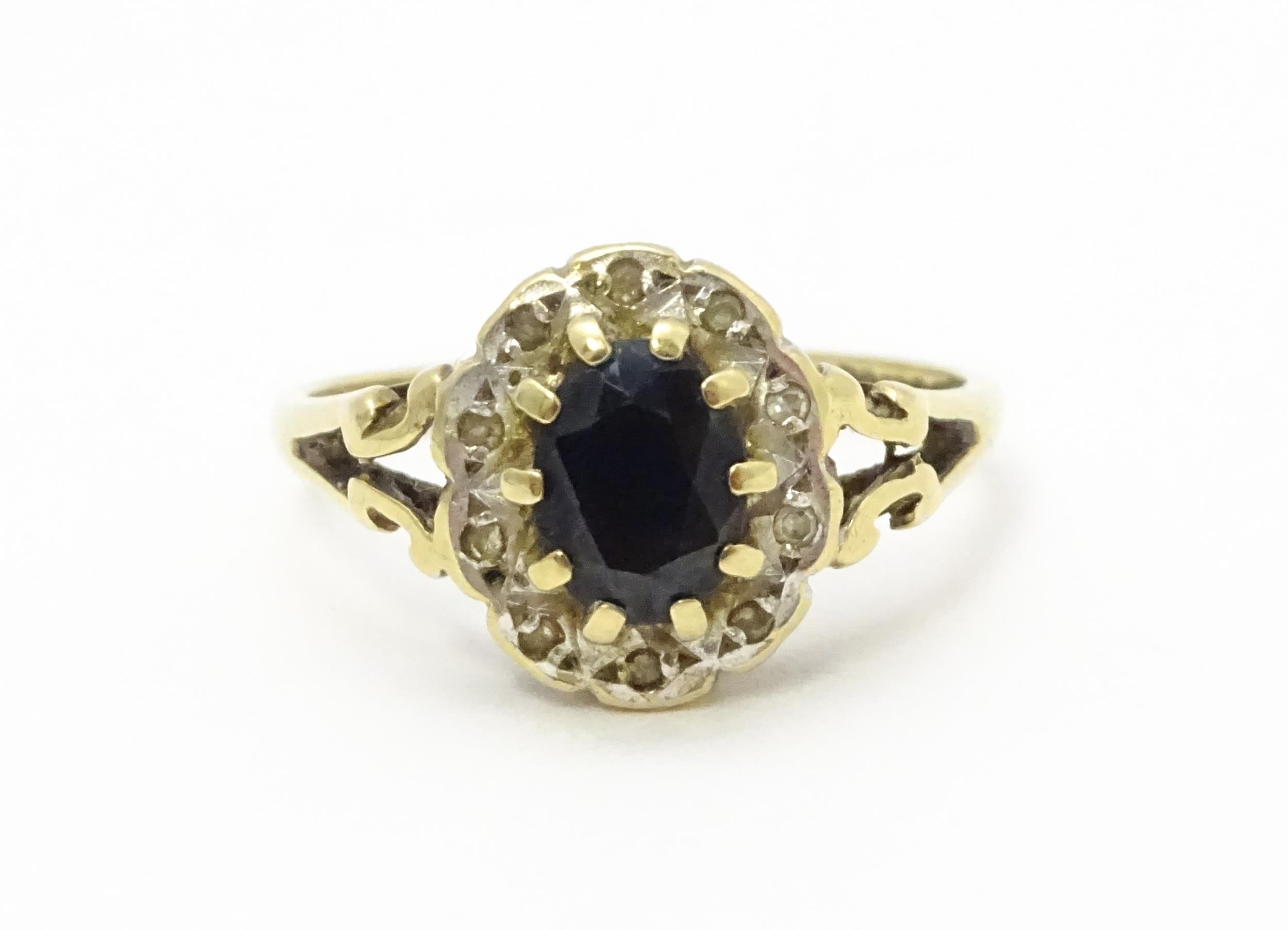 A 9ct gold ring set with central sapphire bordered by diamonds. Ring size approx. L 1/2 Please - Image 10 of 10