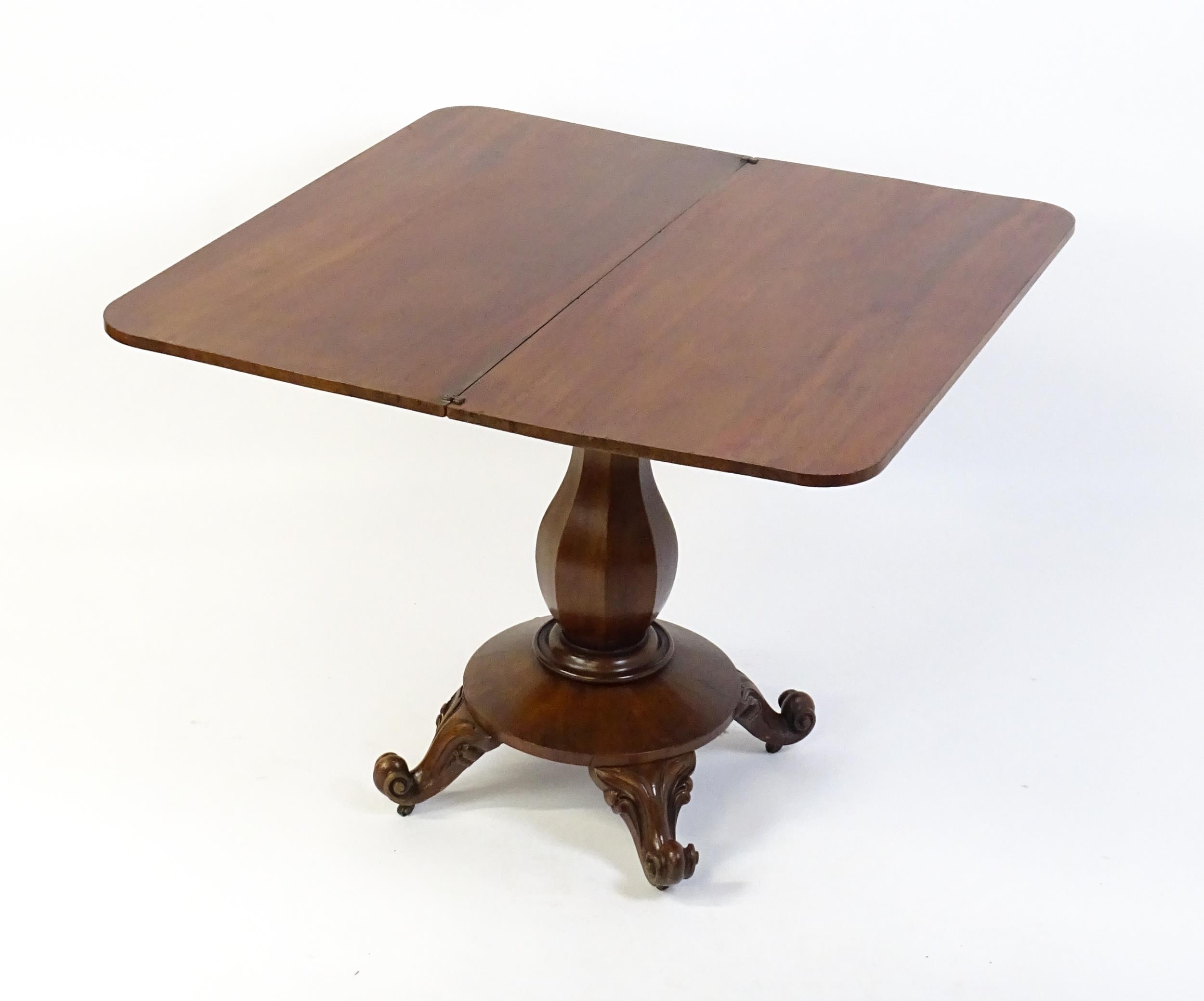 A 19thC mahogany tea table with a carved floral front panel above a canted and shaped pedestal above - Image 2 of 4