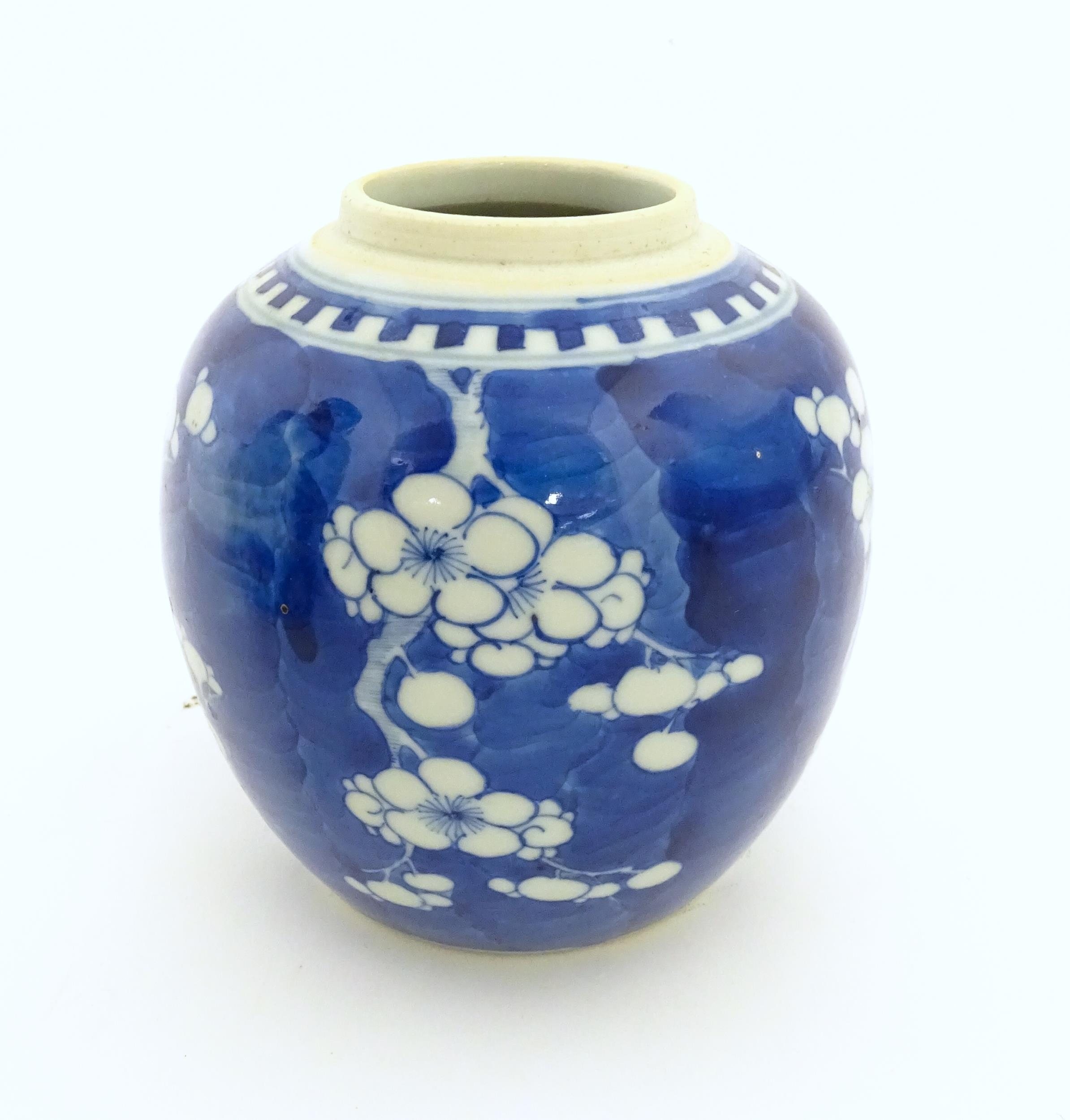 A Chinese blue and white jar decorated with prunus blossom. Character marks under. Approx. 5" high - Image 3 of 7