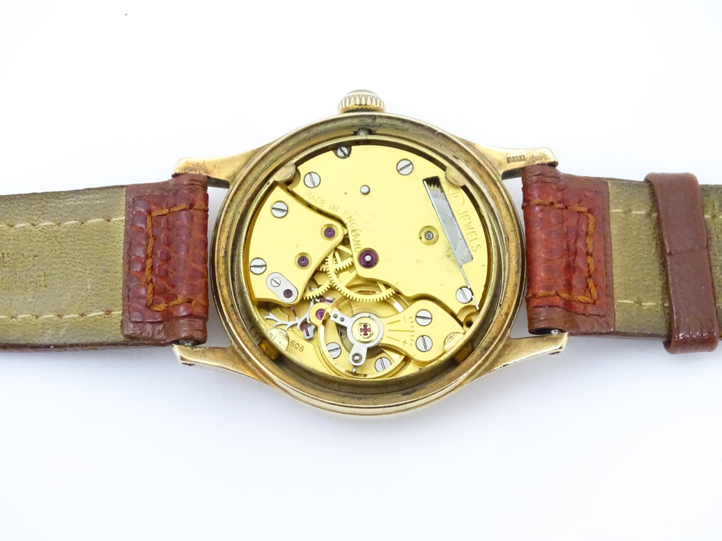 A gentlemans 9ct gold cased wristwatch the dial signed Garrard with Arabic numerals and subsidiary - Image 9 of 11