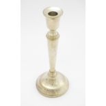 A silver candlestick hallmarked Birmingham 1988, maker C. Ltd. Approx. 10 1/4" high Please Note - we