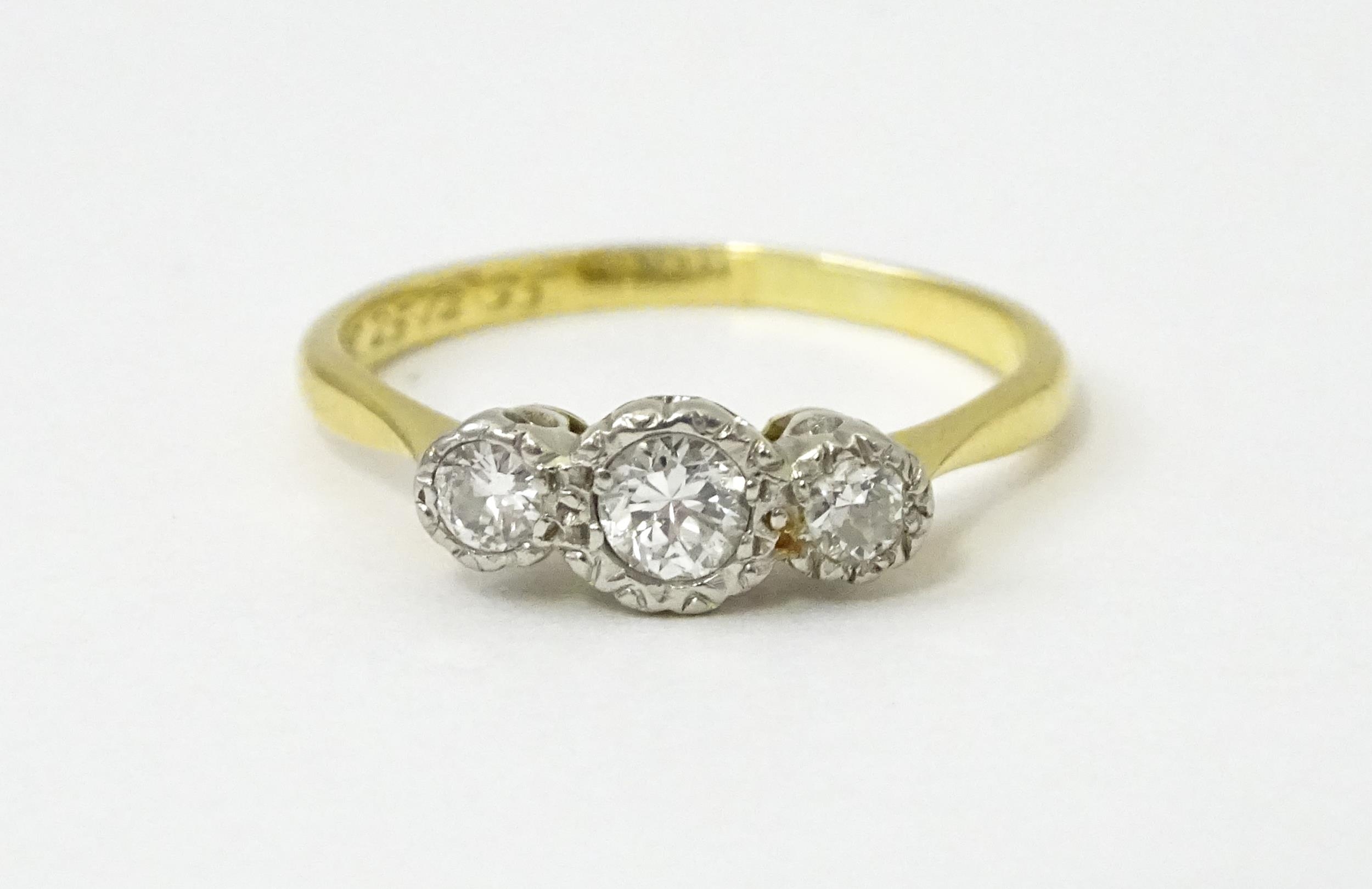 An 18ct gold ring with three platinum set diamonds. Ring size approx. O Please Note - we do not make - Image 18 of 18
