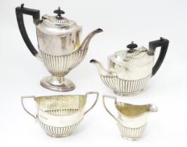 A silver four piece tea set comprising teapot, hot water pot, cream jug and twin handled sugar bowl,