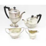 A silver four piece tea set comprising teapot, hot water pot, cream jug and twin handled sugar bowl,