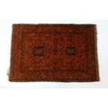 Carpet / Rug: A red ground rug decorated with floral and foliate detail, further repeated to