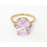 A 9ct rose gold ring set with kunzite flanked by white zircon. Ring size approx. N Please Note -