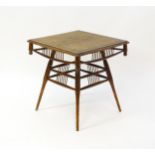 An unusual late 19thC Arts & Crafts table with a rattan inlaid moulded top above three tiers of