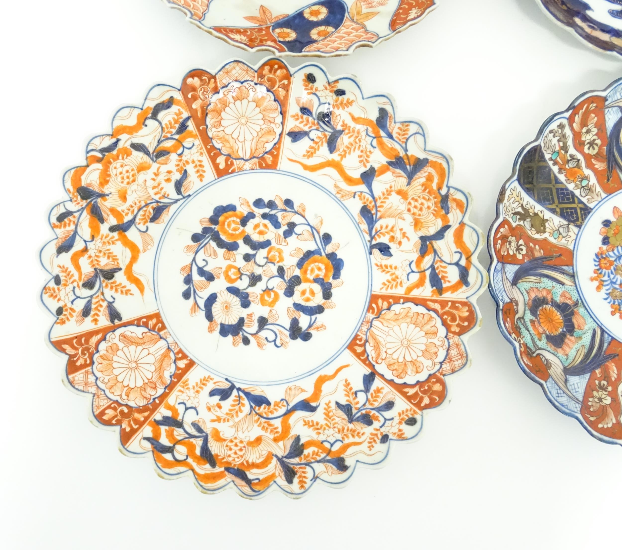 Four Japanese chargers with shaped edges decorated in the Imari palette with flowers, foliage and - Image 4 of 7