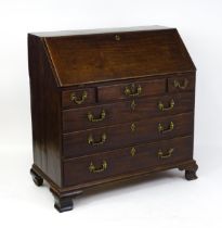 A late 18thC mahogany bureau with a fall front opening to show a fitted interior with pigeon holes
