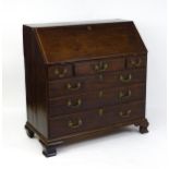 A late 18thC mahogany bureau with a fall front opening to show a fitted interior with pigeon holes