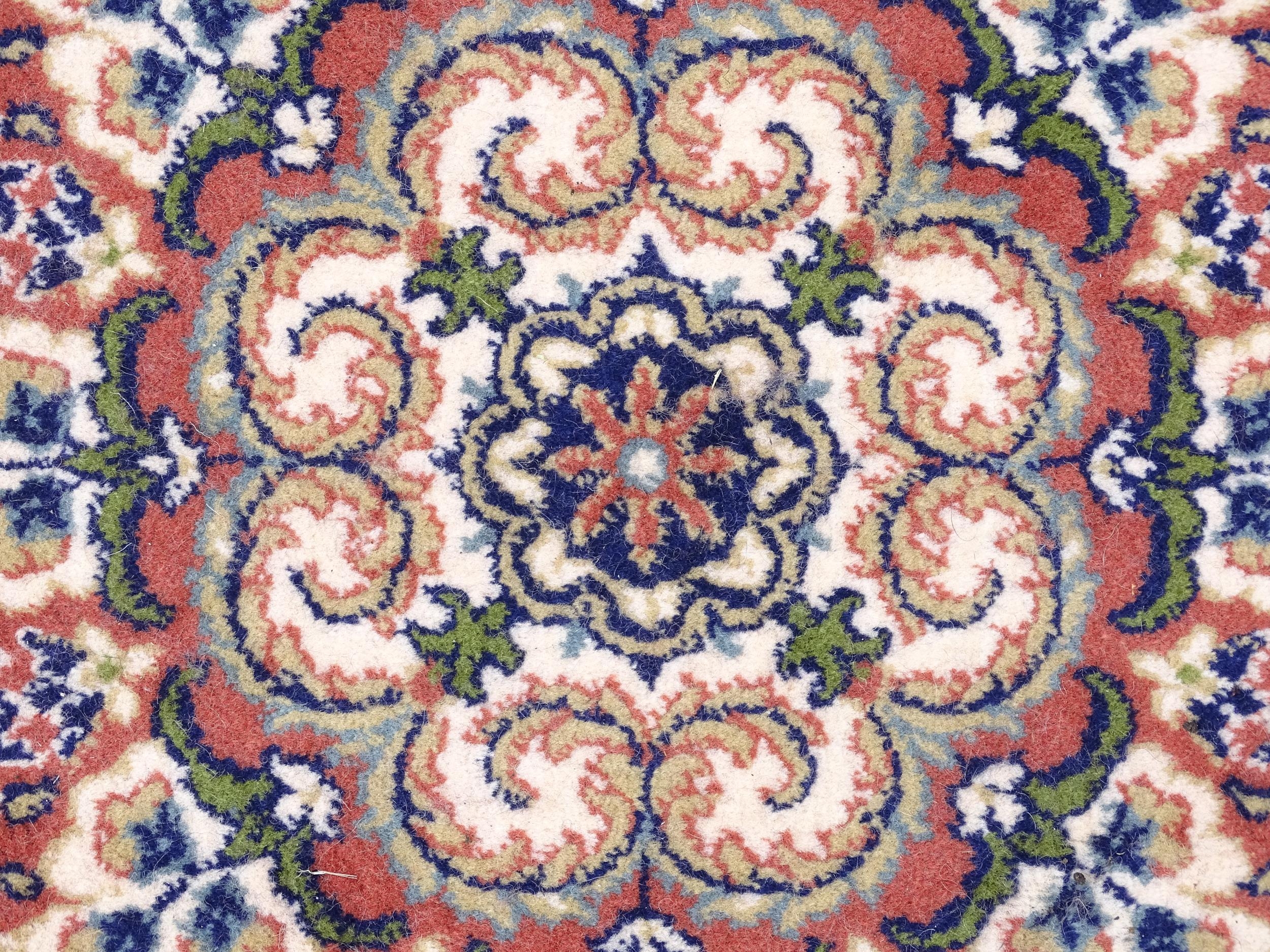 Carpet / Rug : A red ground rug with central floral motif, bordered by floral and foliate scroll - Image 6 of 7