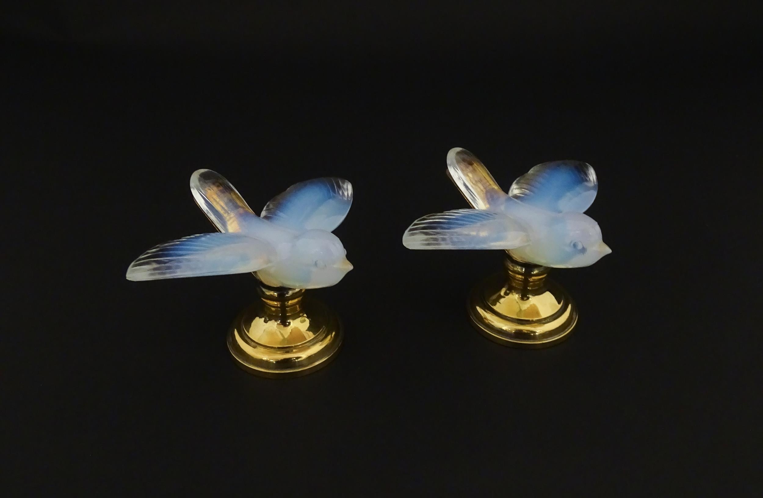 A pair of glass models of swallows raised on French silver gilt stands, stamped Odiot. Approx. 2 1/