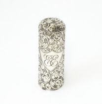 A silver scent / perfume bottle with engraved decoration opening to reveal gilded interior and
