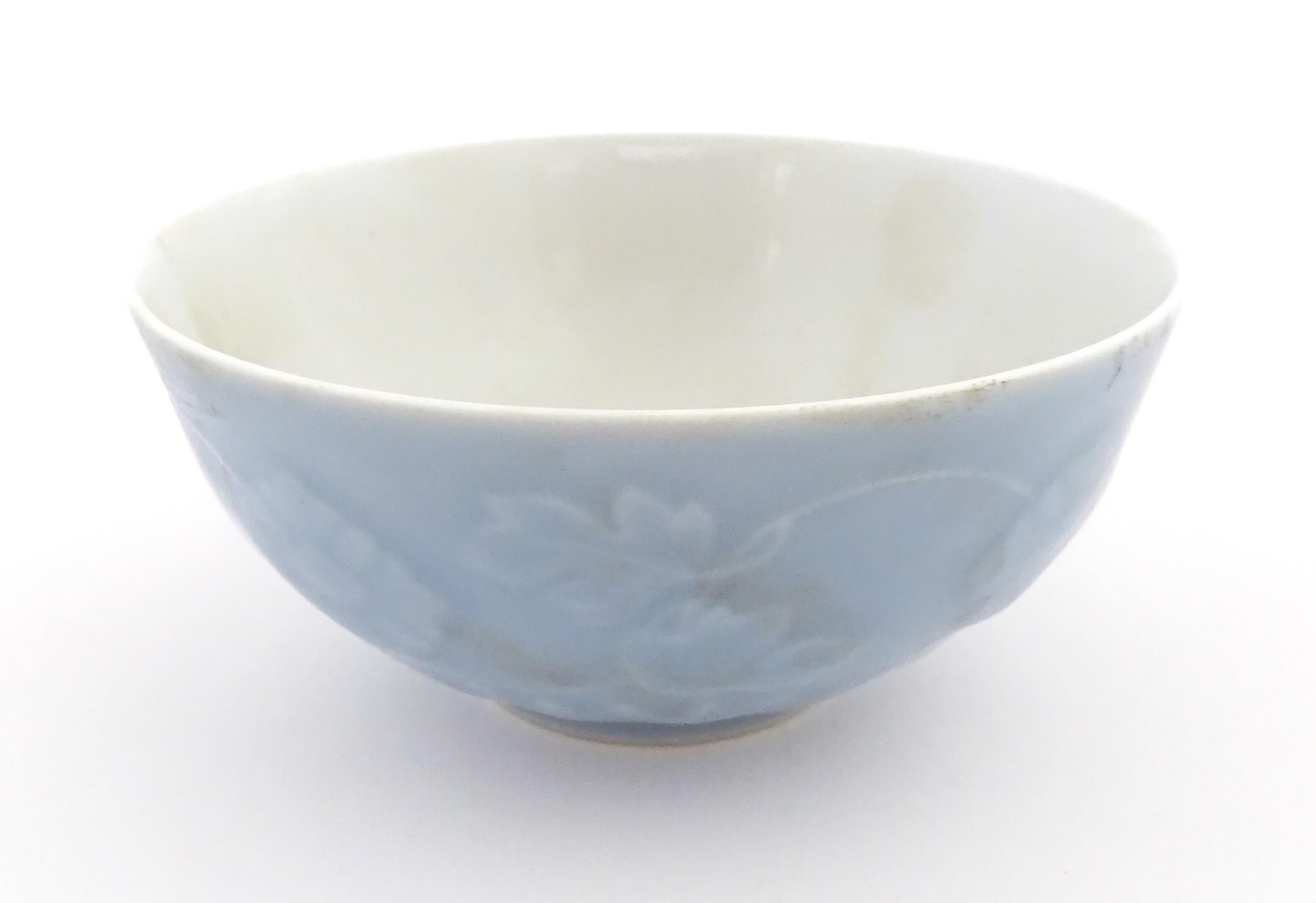 A Chinese bowl with a blue ground decorated with flowers and petals. Character marks under. - Image 2 of 8