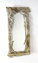 An early 20thC driftwood mirror. 64" high x 32" wide Please Note - we do not make reference to the