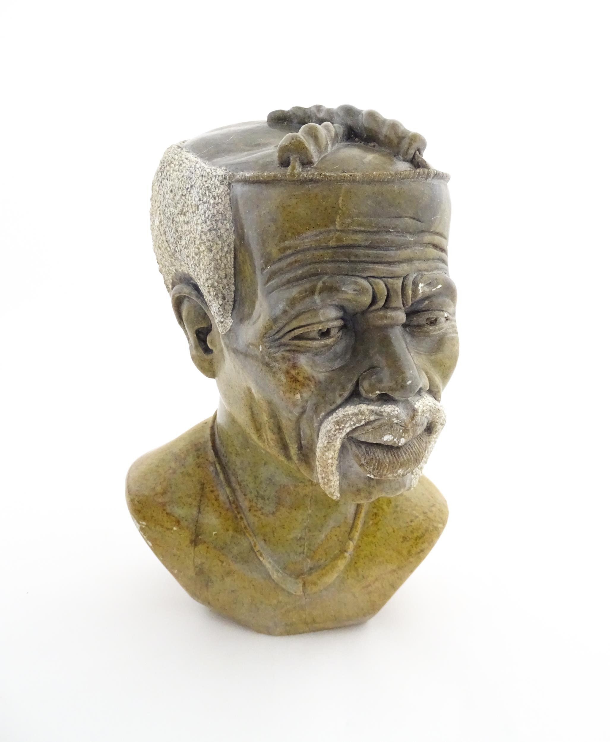 Ethnographic / Native / Tribal : An African carved soapstone bust modelled as a man with a