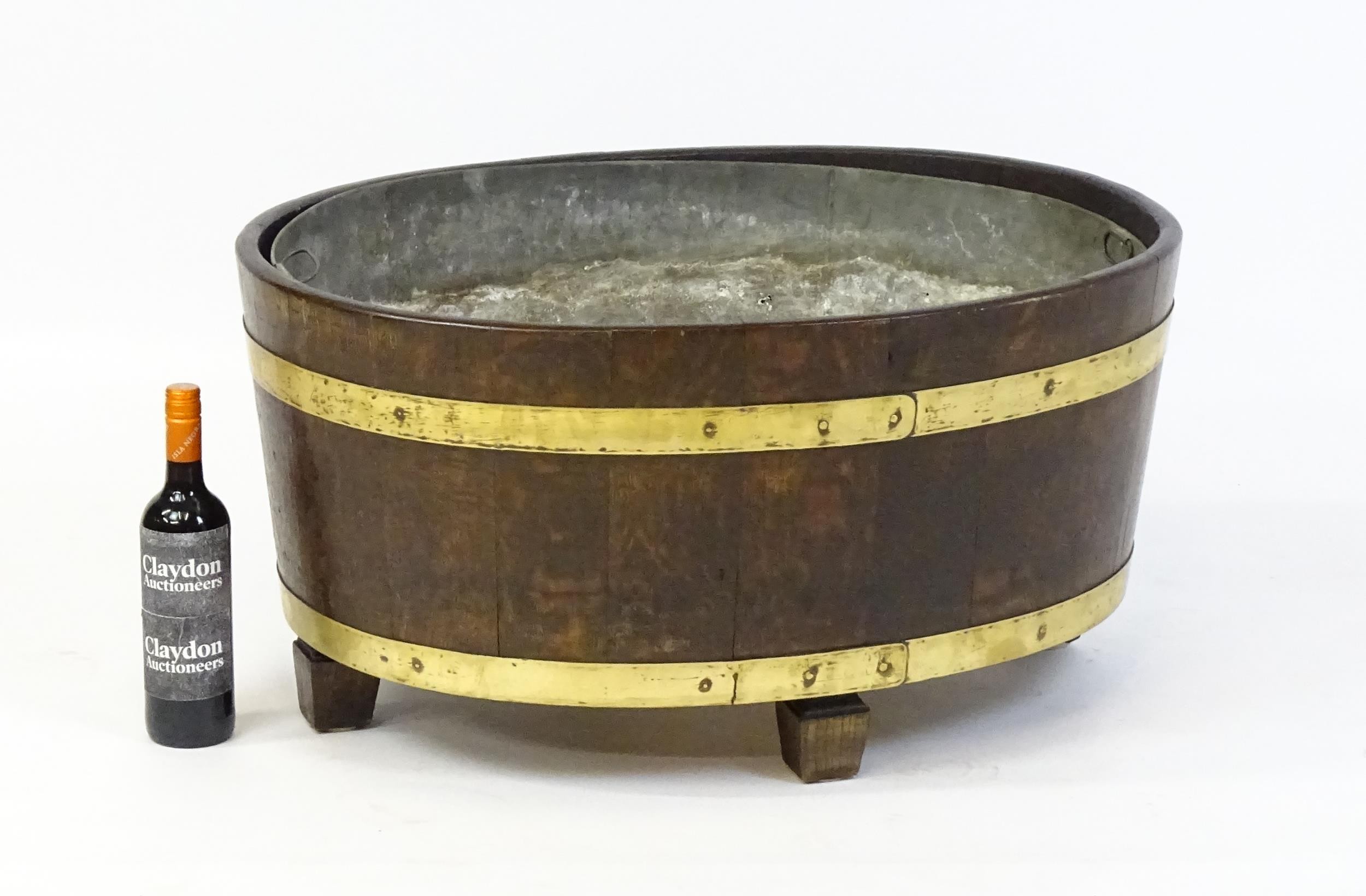 A late Georgian oak wine cooler / cellarette with a coopered and brass strapped frame and raised - Image 2 of 7