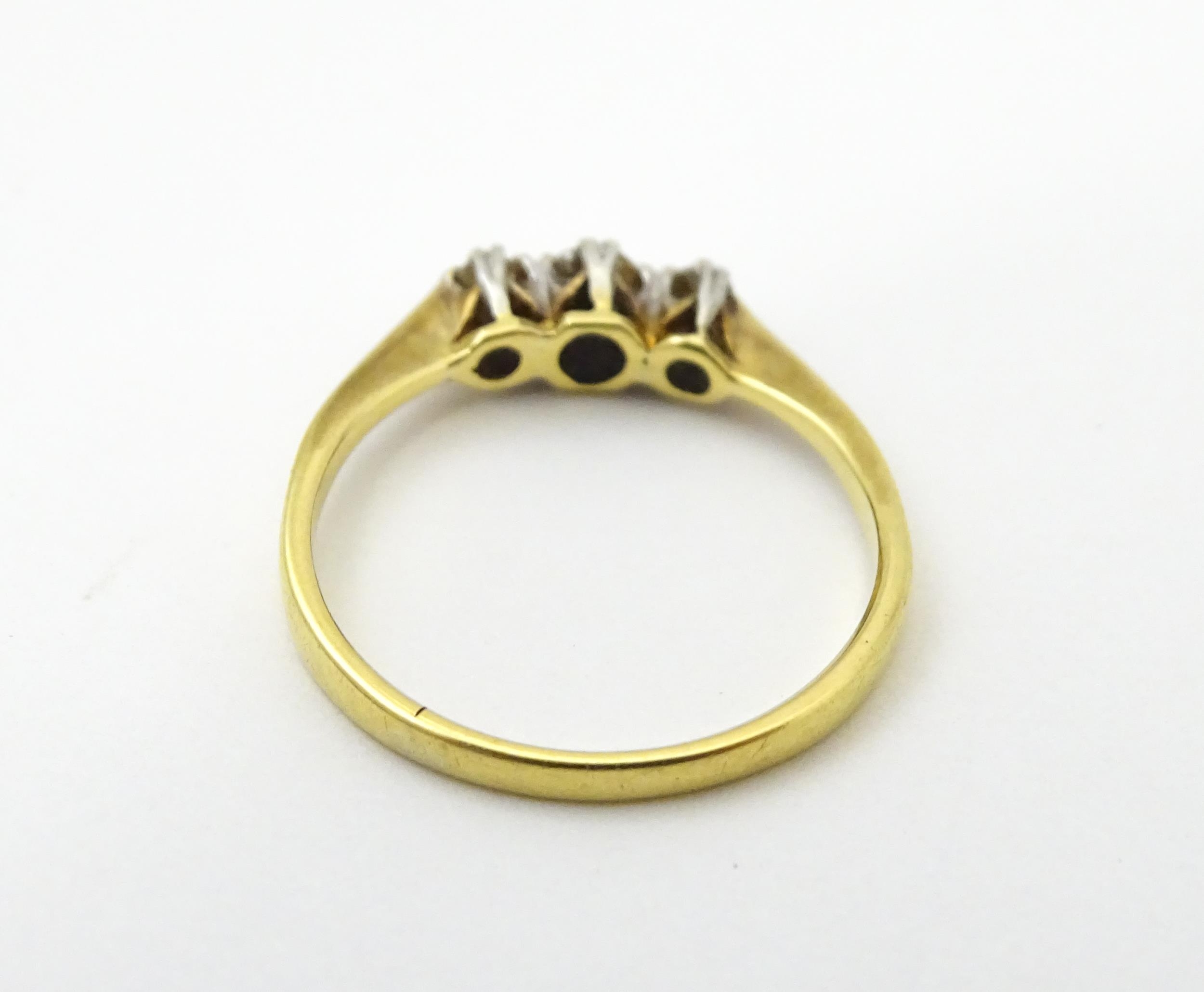 A gold ring set with a trio of diamonds in a platinum setting. Ring size approx. M Please Note - - Image 6 of 6