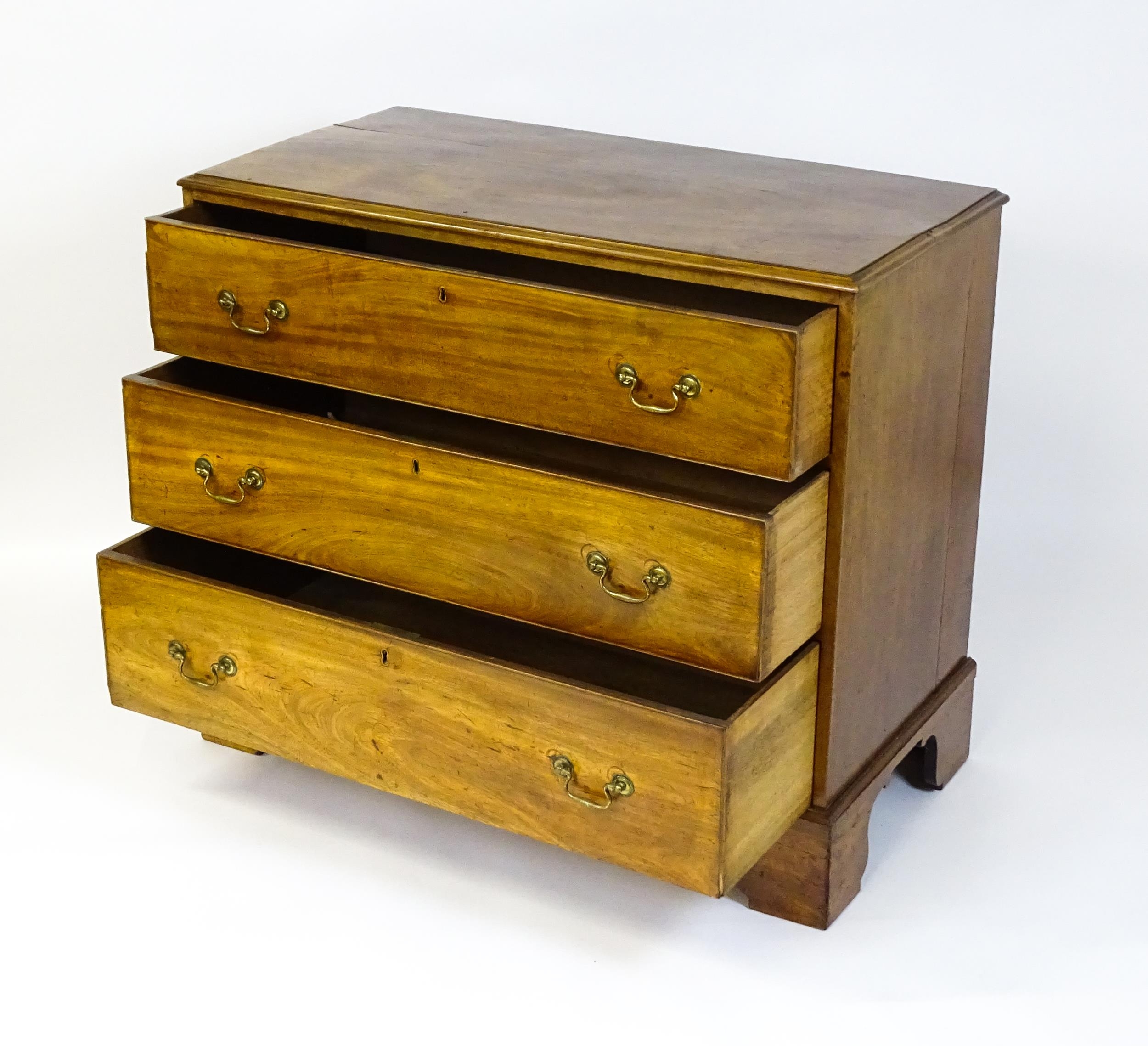 A late Georgian mahogany chest of drawers with a rectangular moulded top above three long drawers - Image 8 of 10