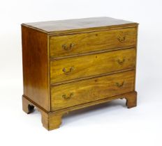 A late Georgian mahogany chest of drawers with a rectangular moulded top above three long drawers