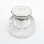 A glass inkwell with silver top hallmarked London 1905 maker James Dudley and stamped J Dudley