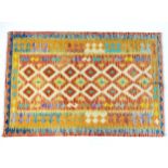 Carpet / Rug : A Turkish Anatolian kilim rug with repeating geometric motifs. Approx. 72" x 48"