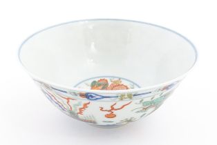 A Chinese bowl decorated with dragons, phoenix birds, flaming pearls and flowers. Character marks