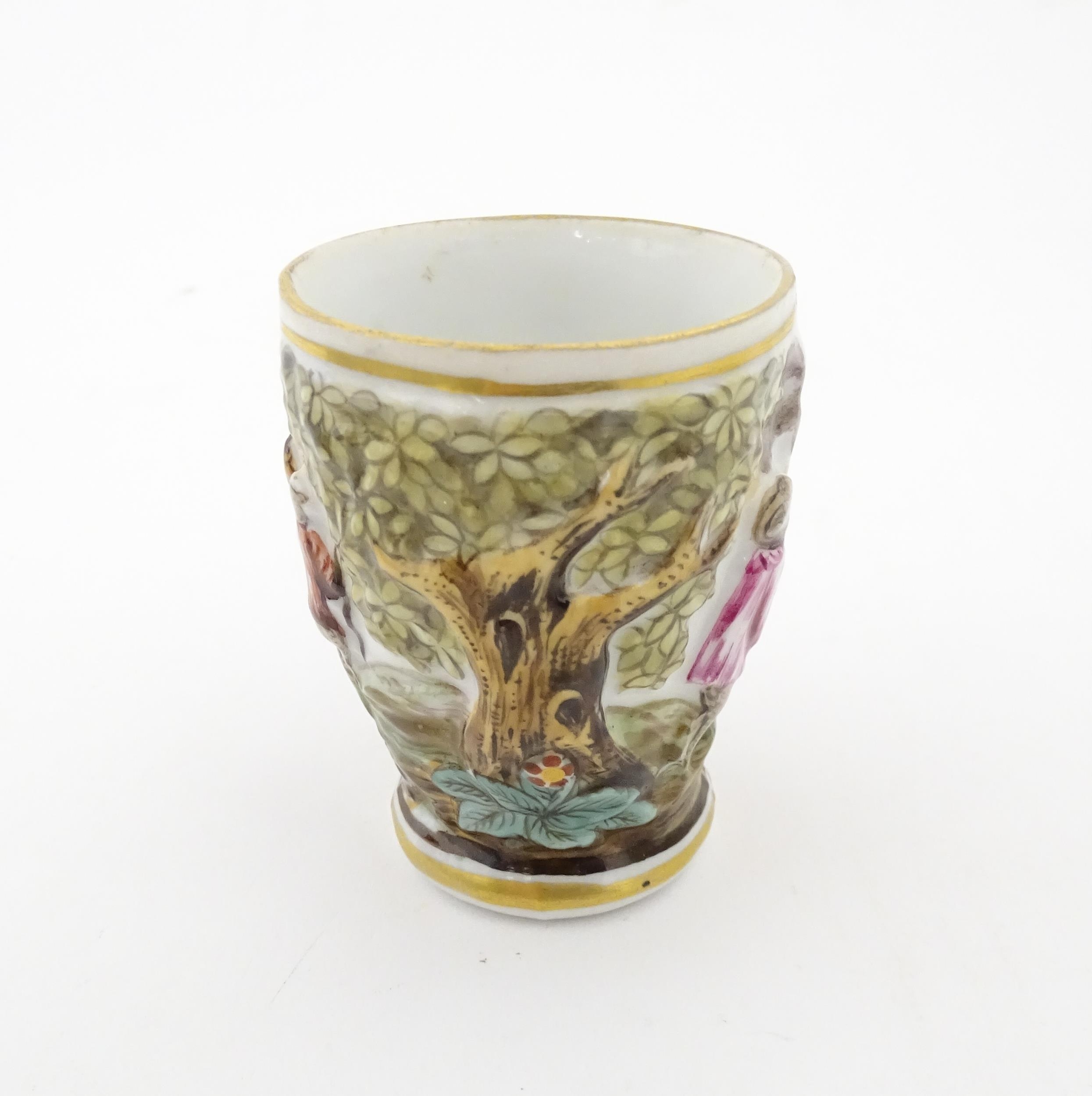 A Continental coffee cup decorated in relief with animals in a landscape. Marked under with - Image 3 of 6
