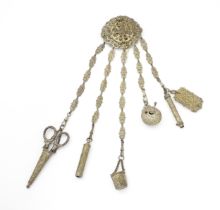 A Victorian silver plate chatelaine with central heraldic armorial, with floral and scroll detail,