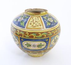 A Sicilian maiolica Bombola vase with panelled and banded decoration depicting flowers and