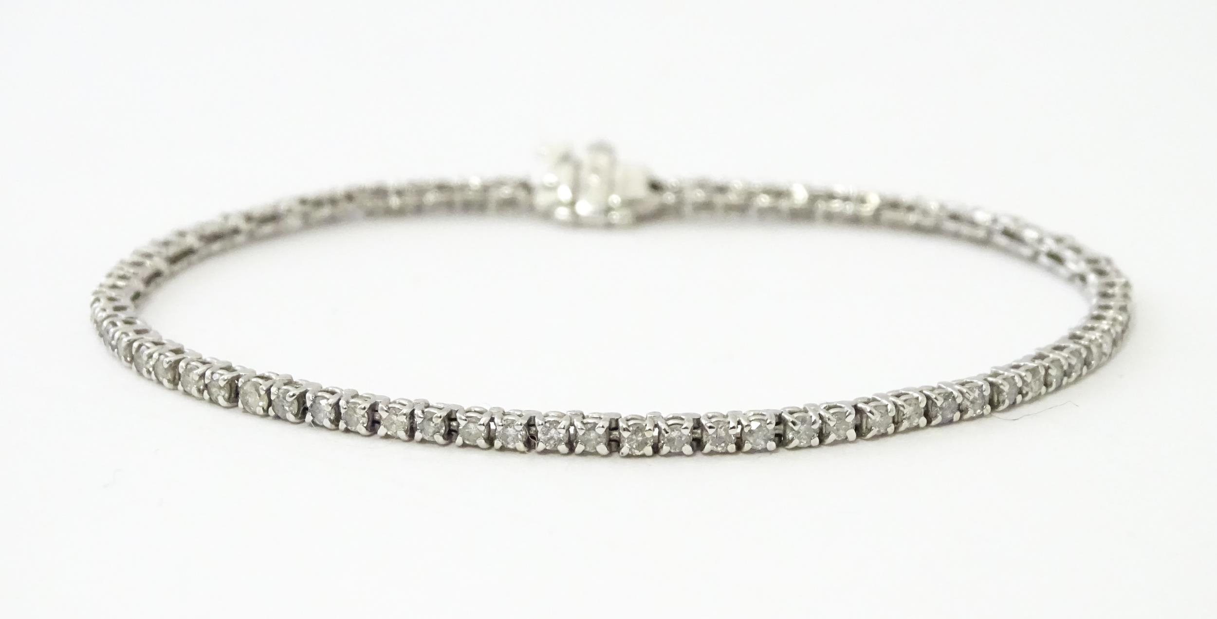 A 14ct white gold tennis bracelet set with diamonds. Approx 7 1/2" long Please Note - we do not make - Image 3 of 10