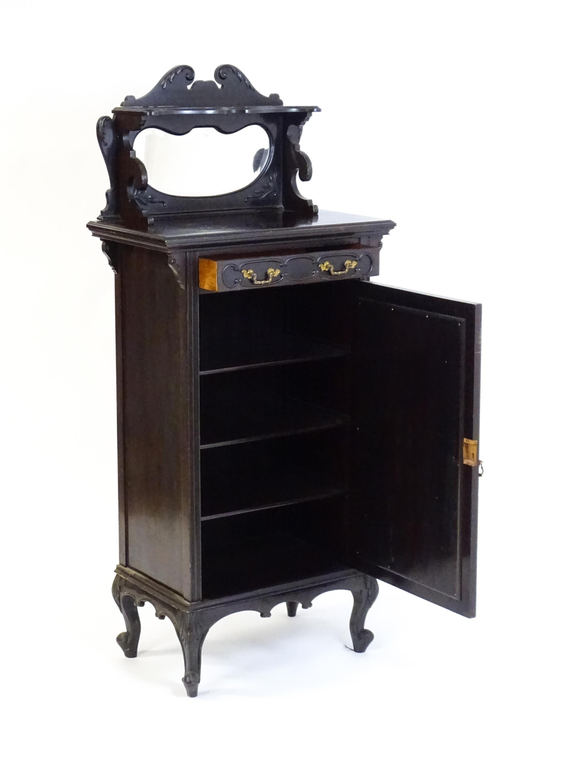 A late Victorian ebonised side cabinet with a mirrored upstand, a moulded top and a single frieze - Image 3 of 6