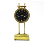A brass cased Gravity clock with dial with Arabic numerals and having exposed escapement. Marked