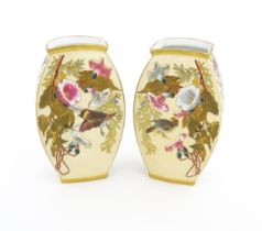 A pair of Limoges Demartial and Tallandier vases of ovoid form decorated with exotic birds,