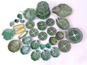 A quantity of assorted cabbage / leaf / vegetable wares to include plates, bowls, cake stand,