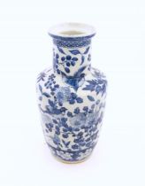 A Chinese blue and white vase decorated with flowers, foliage, fruit, birds and butterflies,