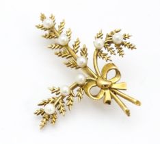 A 9ct gold brooch of foliate form with seed pearl and bow decoration. Approx. 2" long Please