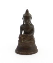 An Asian cast sculpture modelled as a seated Buddha. Approx. 5" high Please Note - we do not make