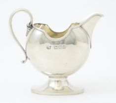 A silver cream jug hallmarked London 1901 maker S W Smith & Co. 3" high Please Note - we do not make