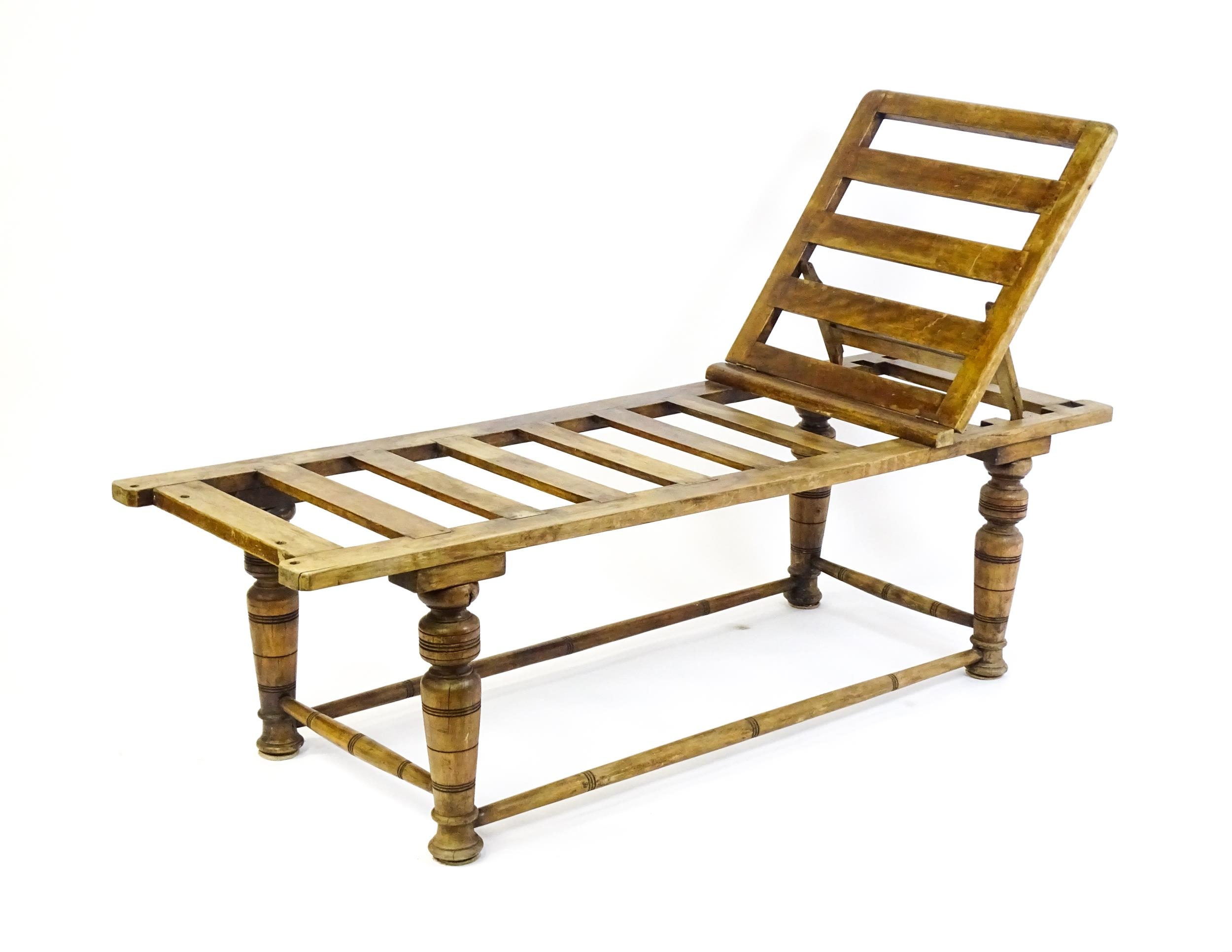 A late 19thC 'Leveson & Sons' campaign bed /day bed with a slatted bed and adjustable headrest above