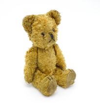Toy: An early 20thC teddy bear with stitched nose and mouth and articulated limbs. Approx. 9 1/4"