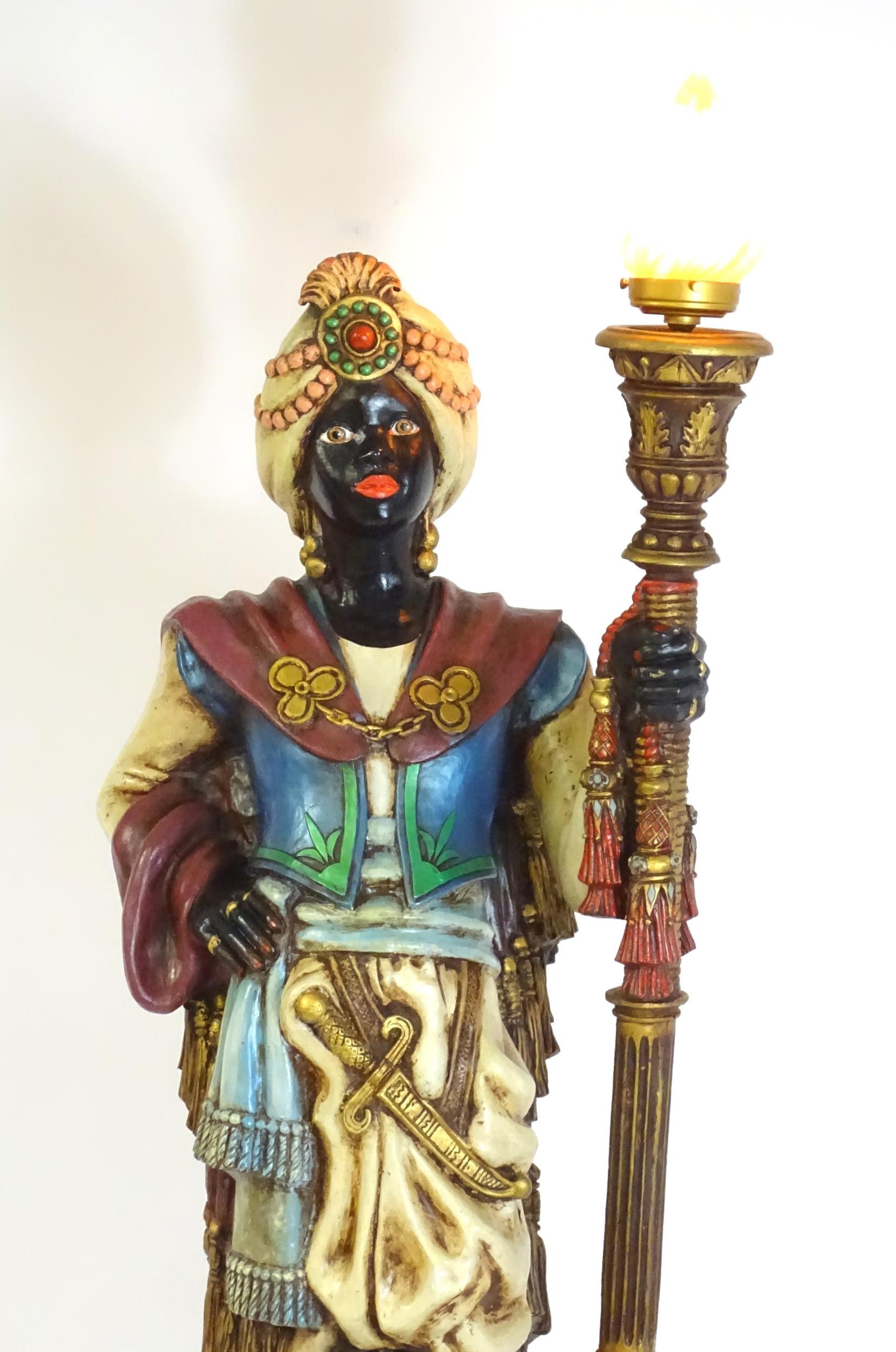 A mid 20thC blackamoor lamp, the lamp having a polychrome figural top grasping a torchiere, the - Image 5 of 14