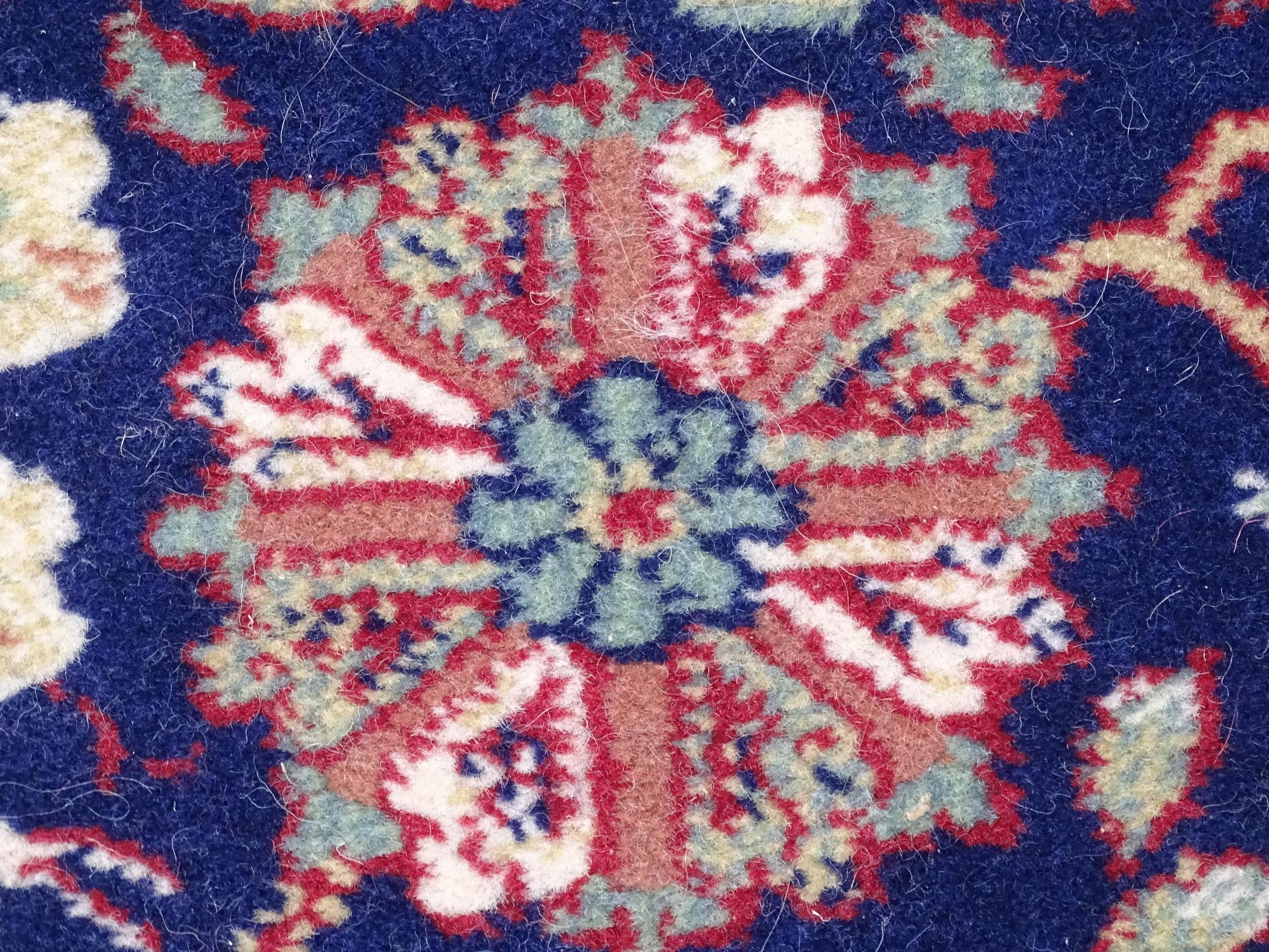 Carpet / Rug : A blue ground wool rug decorated with floral and foliate detail, further repeated - Image 7 of 9