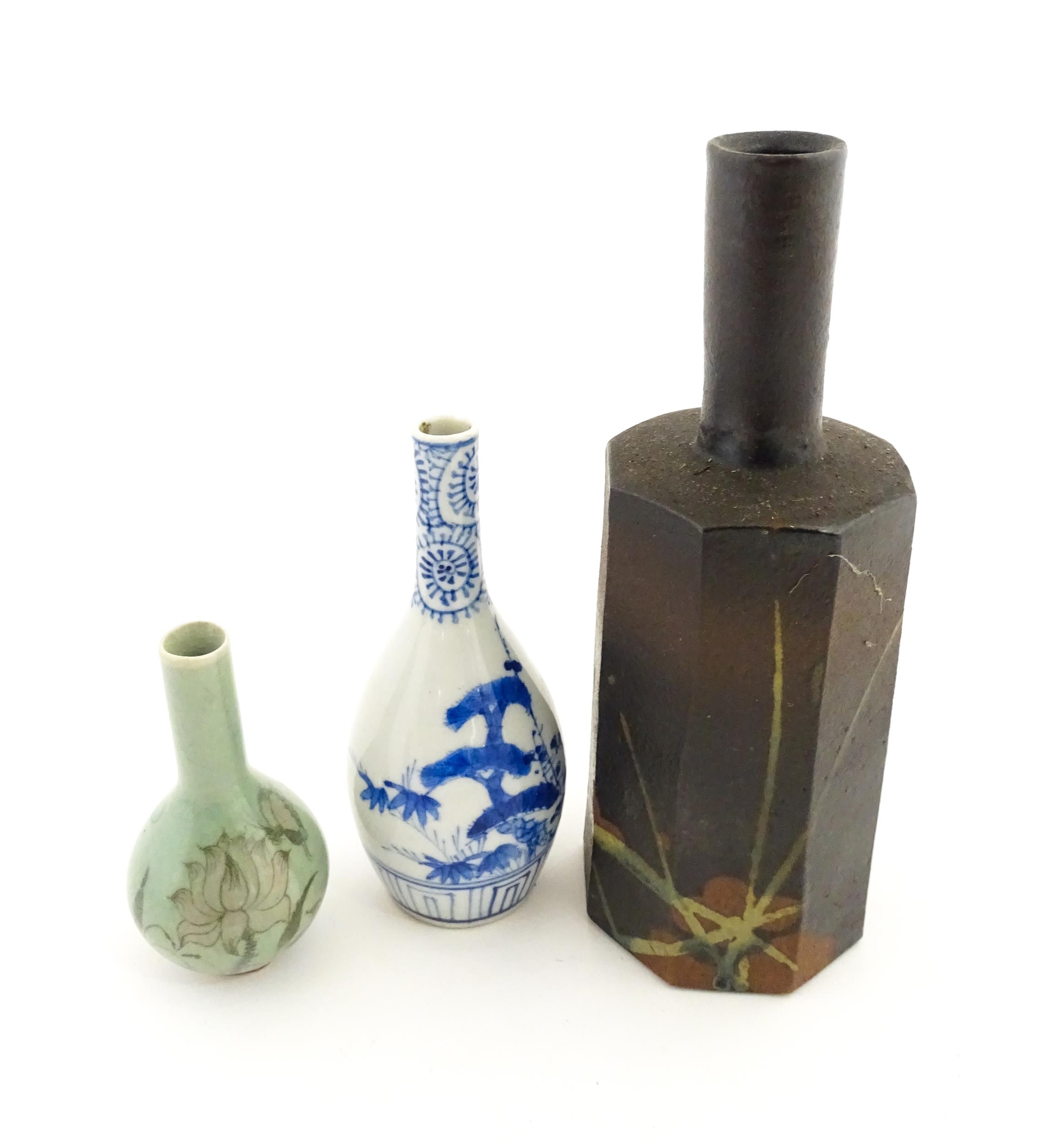 A Japanese studio pottery vase with octagonal body, elongated neck and brushwork detail. Together
