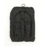 A naive carved wooden plaque depicting the crucifixion of Christ with the Virgin Mary and St.