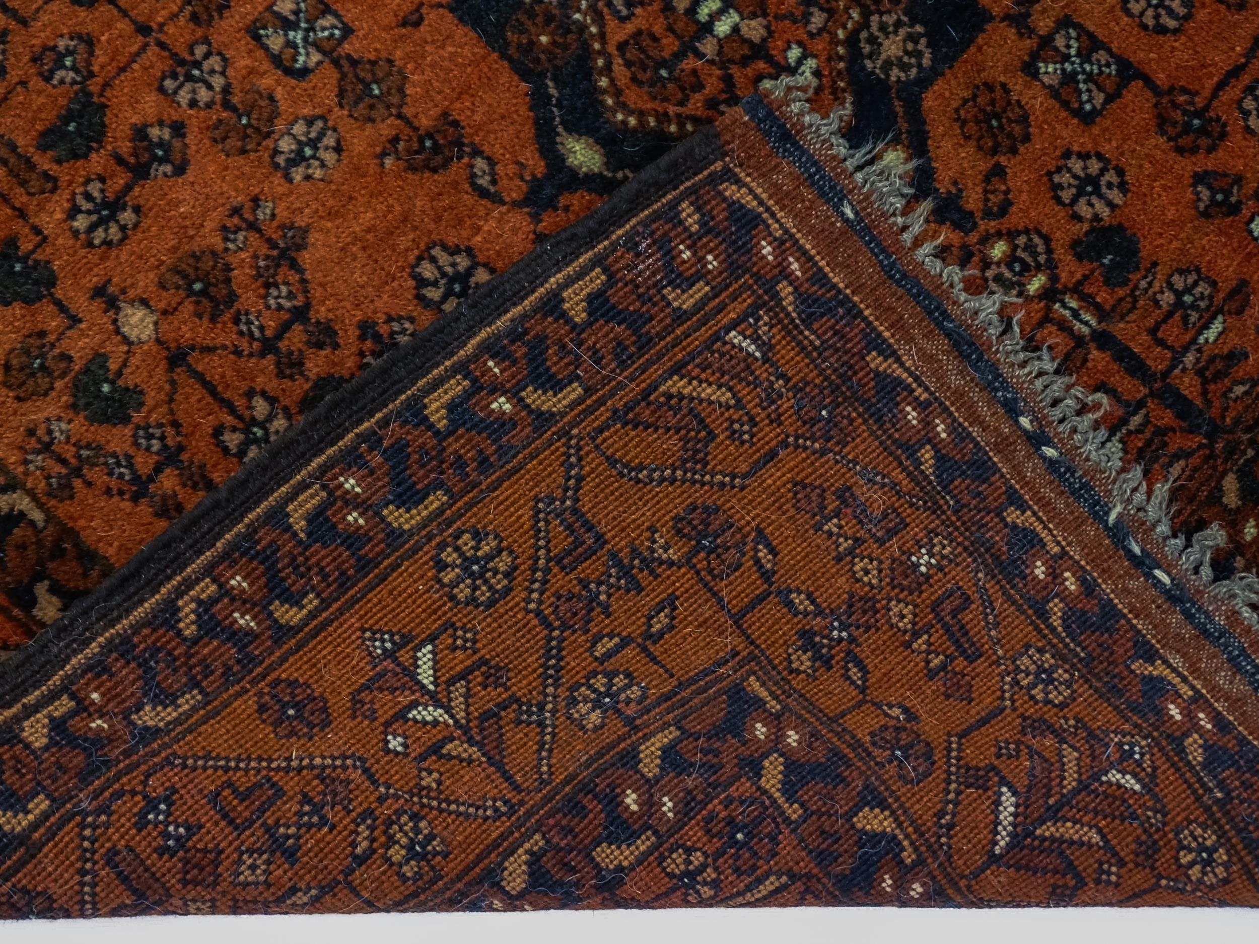 Carpet / Rug: A red ground rug decorated with floral and foliate detail, further repeated to - Image 2 of 8