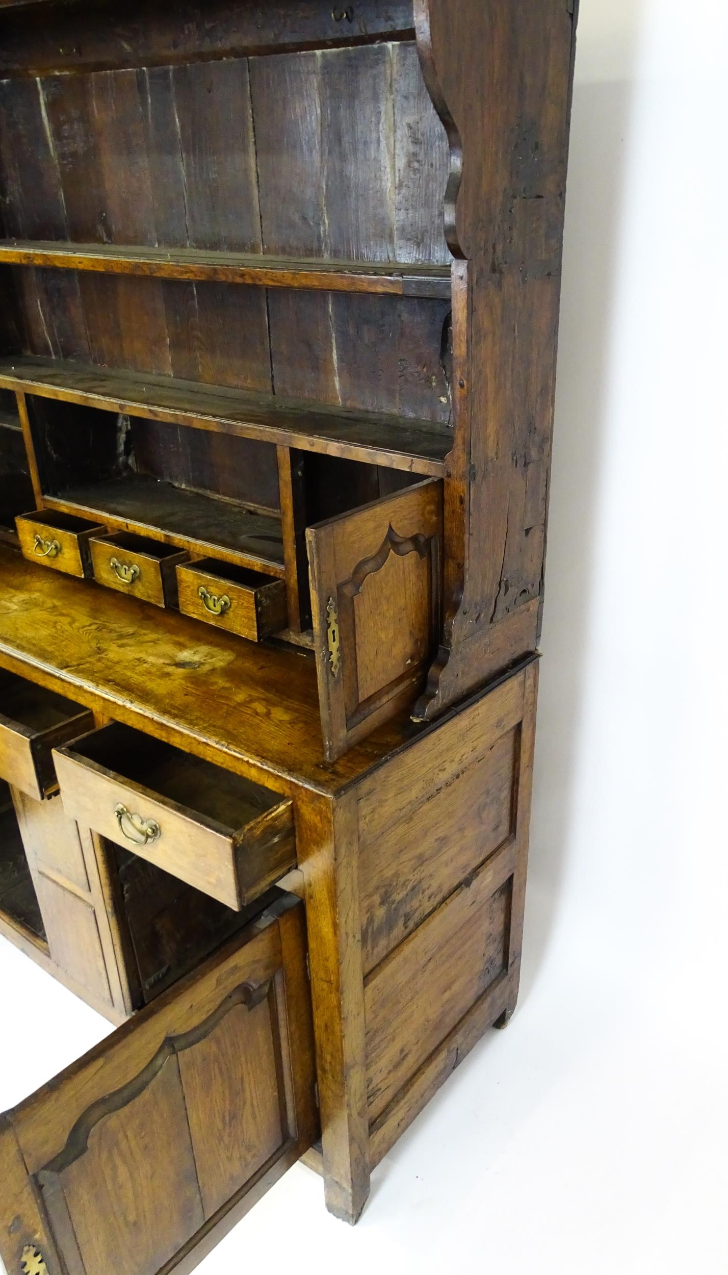 A mid 18thC oak dresser with a moulded cornice above three graduated shelves flanked by panelled - Image 2 of 9