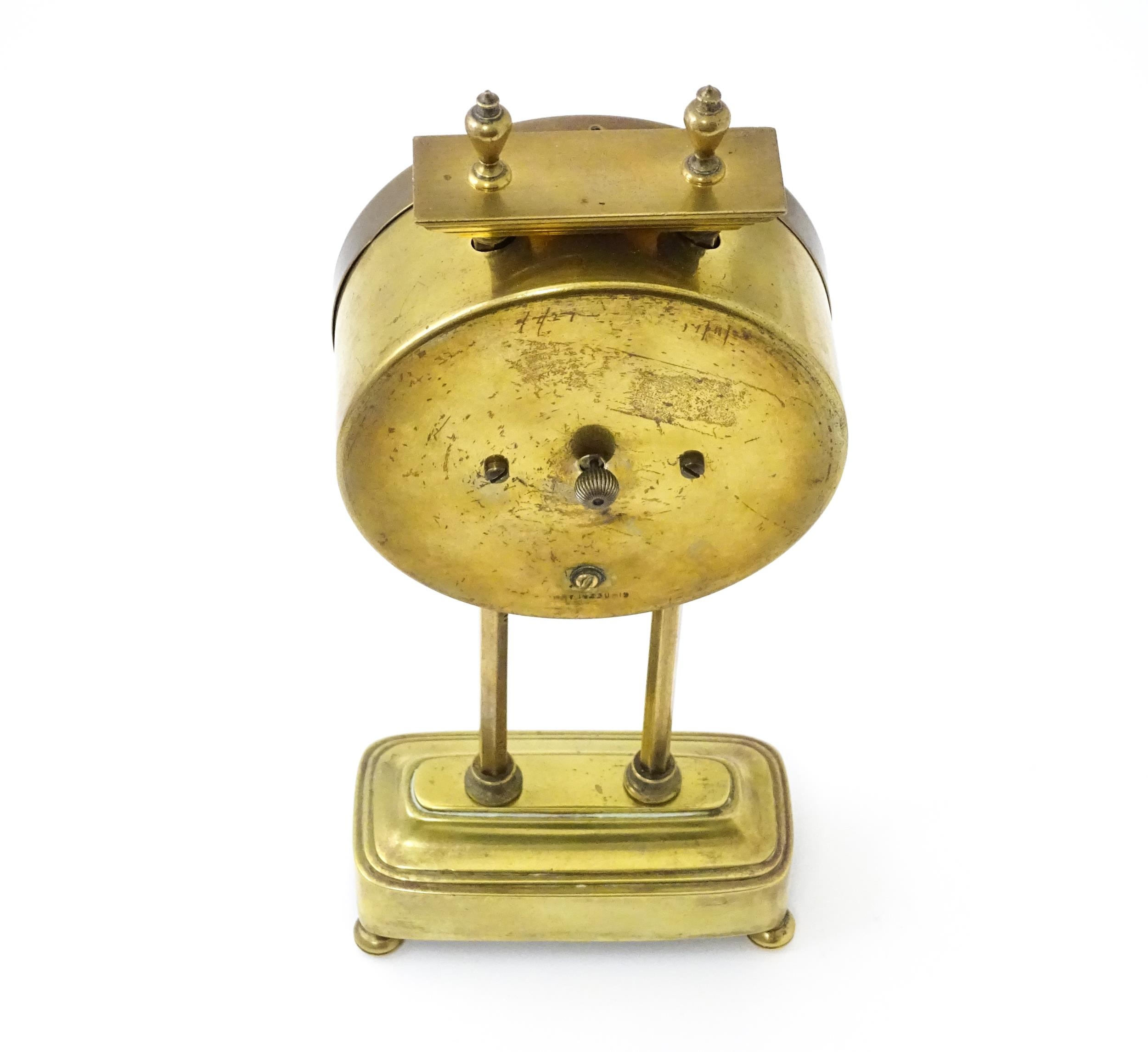 A brass cased Gravity clock with dial with Arabic numerals and having exposed escapement. Marked - Image 2 of 9